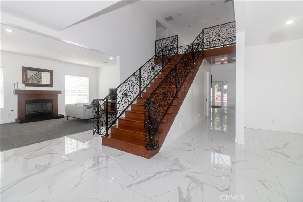17423 Wicker Way Riverside, CA 92504 - Photo 8 of 66 a living room with stairs and a fireplace