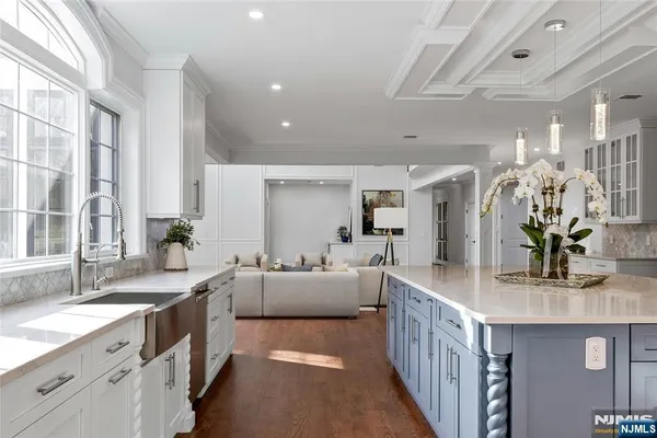 a large white kitchen with a large window