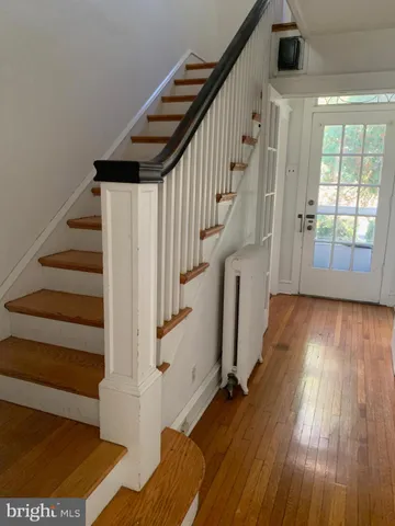a view of entryway with wooden floor and stairs