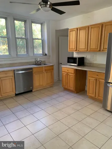 a kitchen with stainless steel appliances granite countertop a sink and a stove top oven