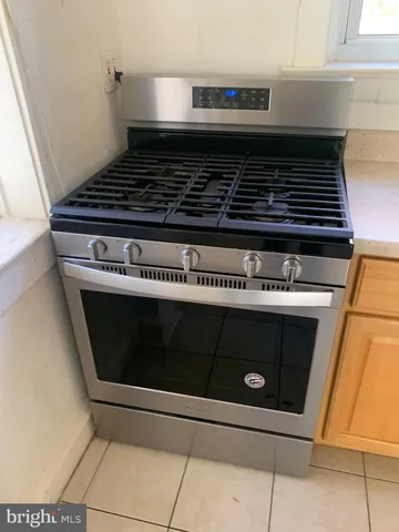 a stove top oven sitting inside of a kitchen