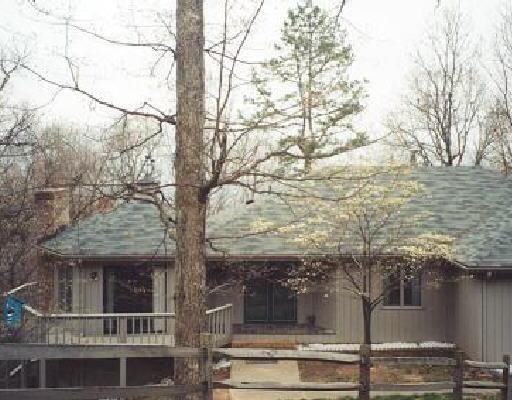 a view of a house with a tree