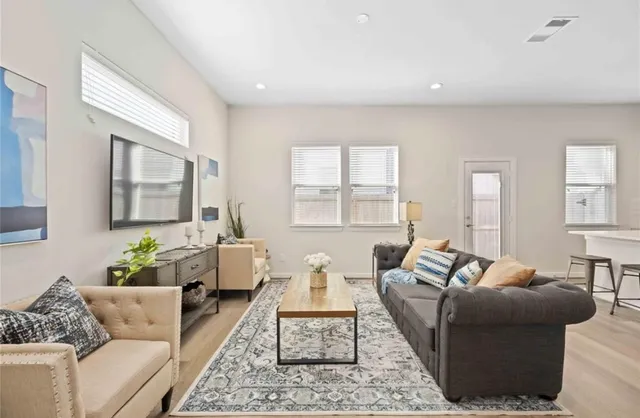 a living room with furniture and a large window