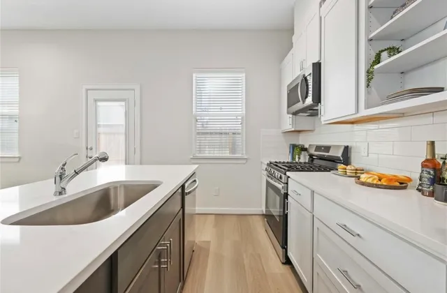 a kitchen that has a sink and a stove