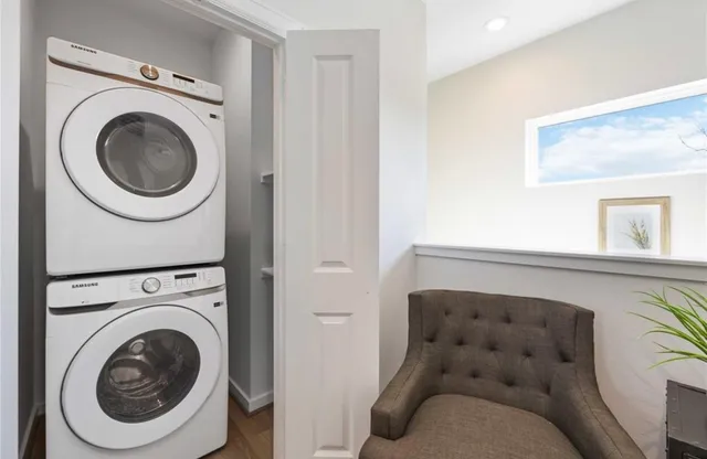 a living room with a couch and a washer dryer