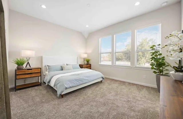 a spacious bedroom with a bed and a window