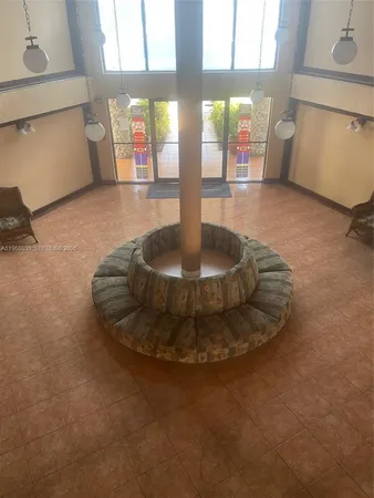 a view of a lobby with chair and window