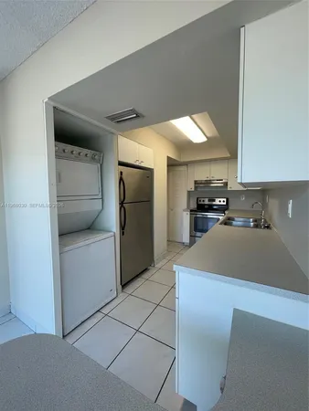 a kitchen with stainless steel appliances a refrigerator and a stove