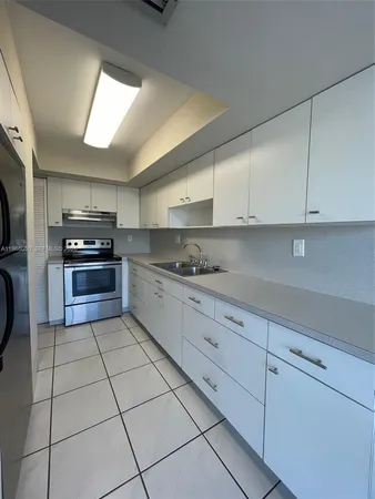 a kitchen with stainless steel appliances granite countertop a sink and a stove