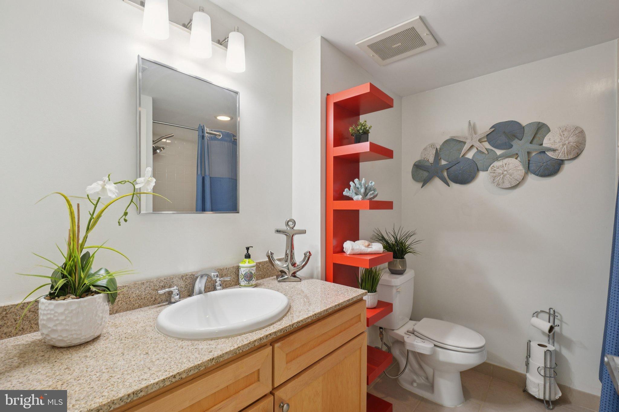 1150 K Street Northwest, Unit 1111 Washington, DC 20005 - Photo 17 of 36 a bathroom with a toilet sink and mirror