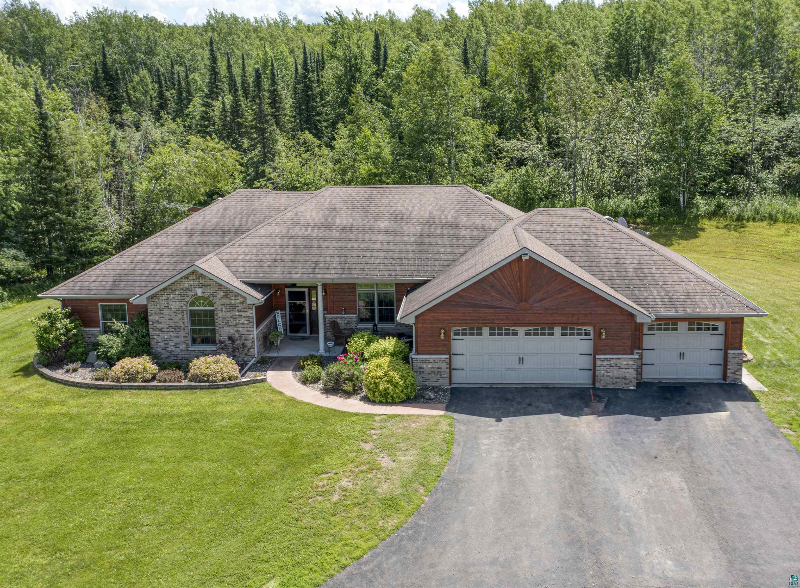 4678 Ridgeview Drive Superior, WI 54880 - Photo 1 of 43 View of front of property featuring a garage, a front lawn, and covered porch