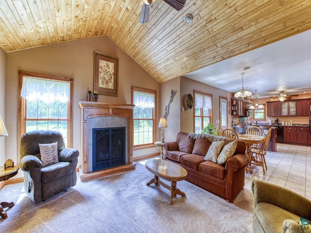4678 Ridgeview Drive Superior, WI 54880 - Photo 11 of 43 Tiled living room with ceiling fan with notable chandelier, vaulted ceiling, and wooden ceiling