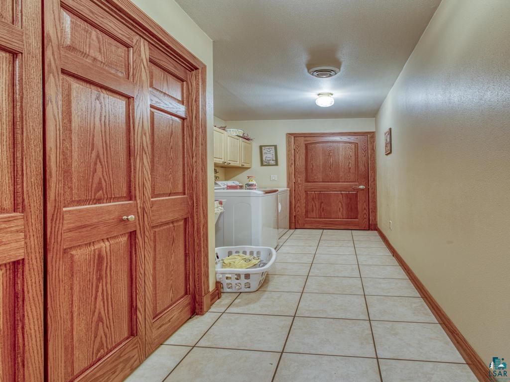 4678 Ridgeview Drive Superior, WI 54880 - Photo 14 of 43 Corridor with separate washer and dryer and light tile patterned floors