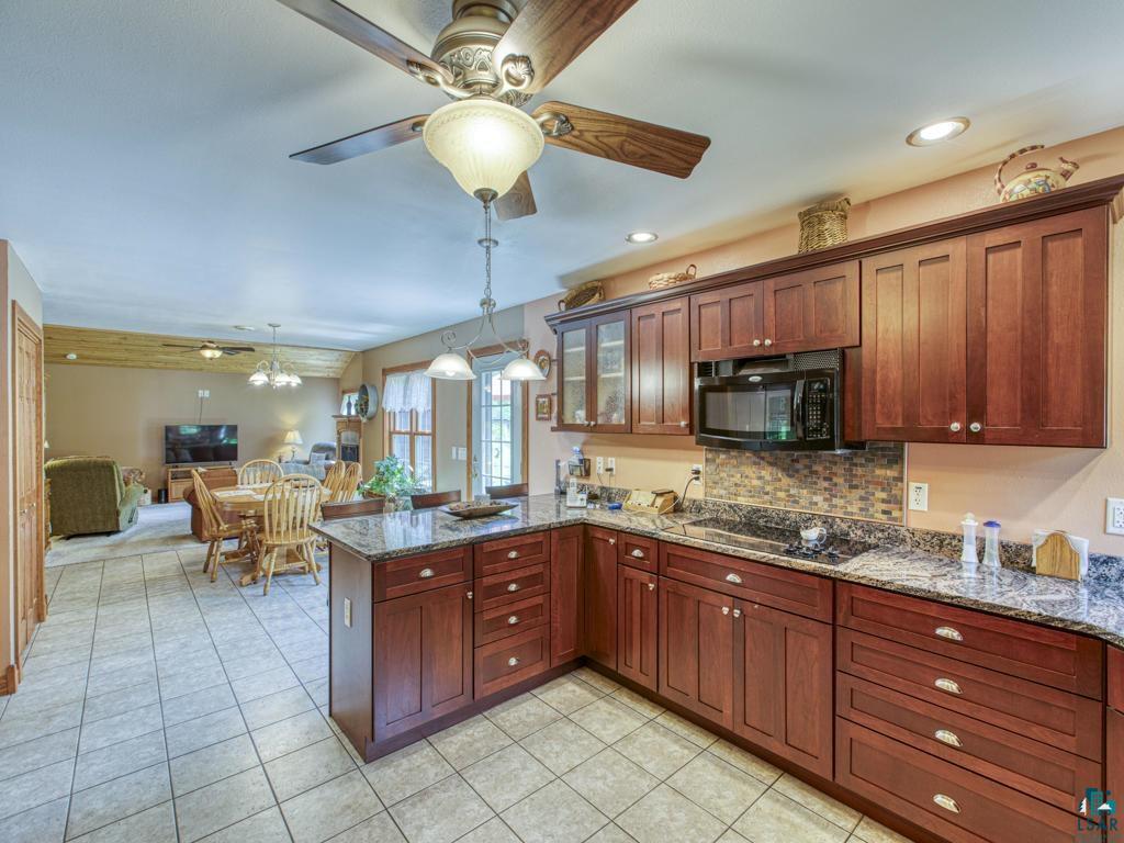4678 Ridgeview Drive Superior, WI 54880 - Photo 4 of 43 Kitchen with pendant lighting, light tile patterned floors, black appliances, and ceiling fan