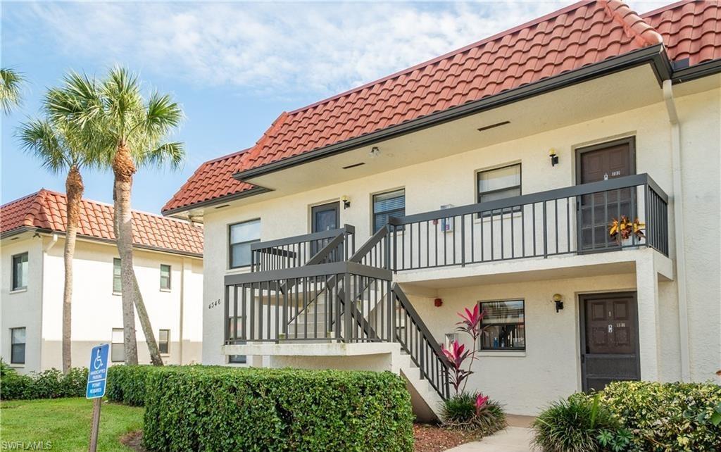 4346 27th Court Southwest, Unit 5 Naples, FL 34116 - Photo 1 of 18 a front view of a house with a yard
