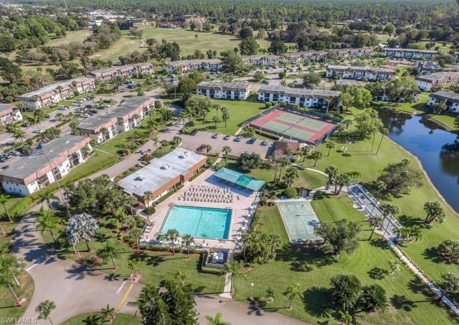 4346 27th Court Southwest, Unit 5 Naples, FL 34116 - Photo 11 of 18 an aerial view of residential houses with outdoor space