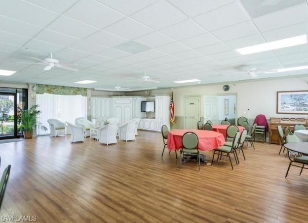 4346 27th Court Southwest, Unit 5 Naples, FL 34116 - Photo 12 of 18 a view of a livingroom with furniture window and wooden floor