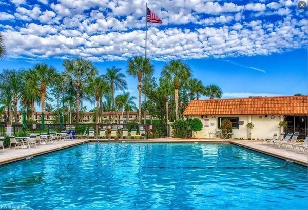 a view of a swimming pool with an outdoor space and seating area