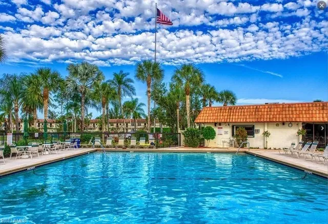 a view of a swimming pool with an outdoor space and seating area