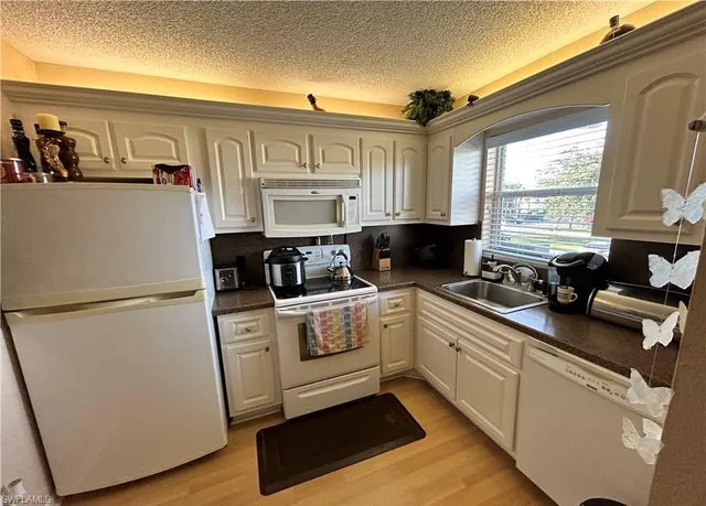 a kitchen with stainless steel appliances a refrigerator sink and cabinets