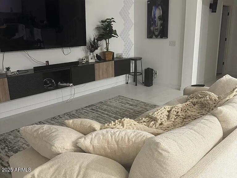 41848 West Hillman Drive Maricopa, AZ 85138 - Photo 2 of 11 a living room with a couch and a flat screen tv