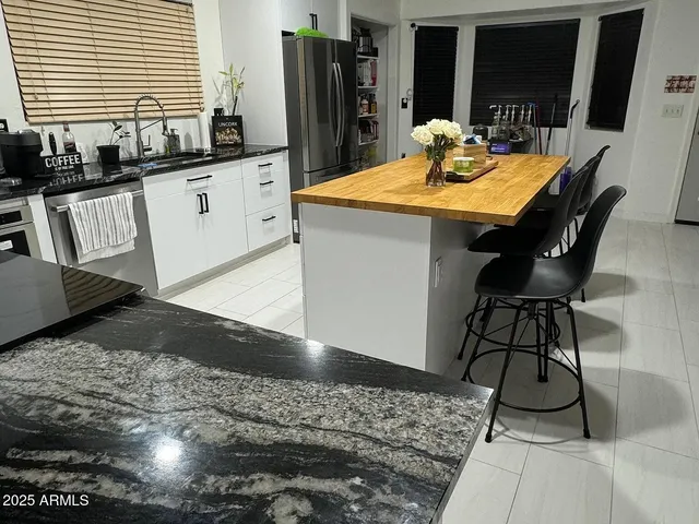 a kitchen with sink and refrigerator