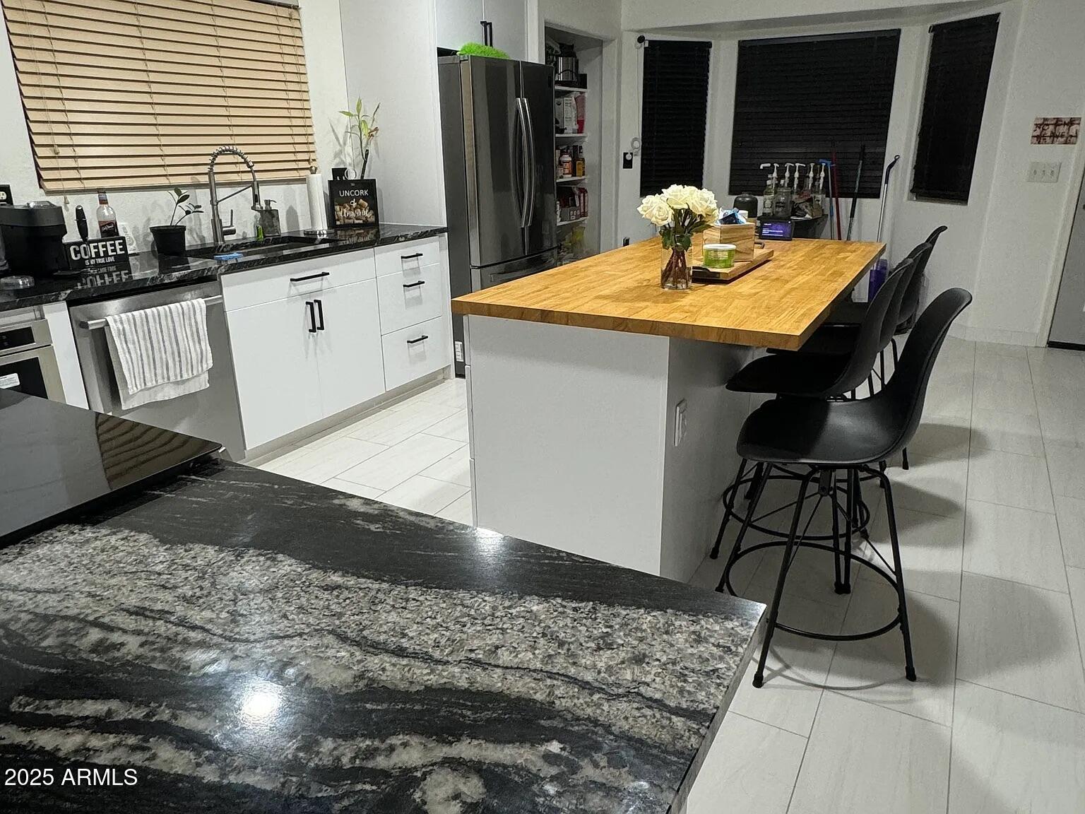 41848 West Hillman Drive Maricopa, AZ 85138 - Photo 4 of 11 a kitchen with sink and refrigerator