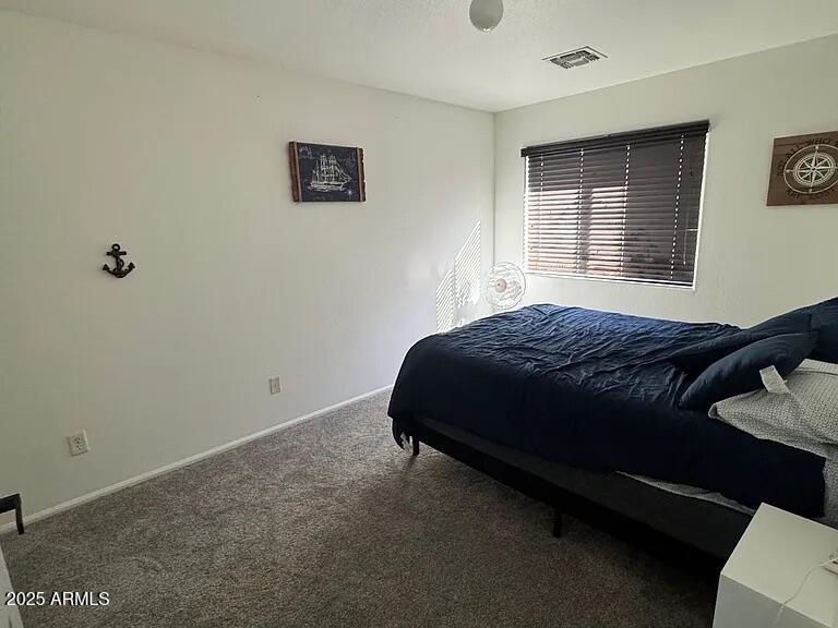 41848 West Hillman Drive Maricopa, AZ 85138 - Photo 5 of 11 a bedroom with a bed and a window