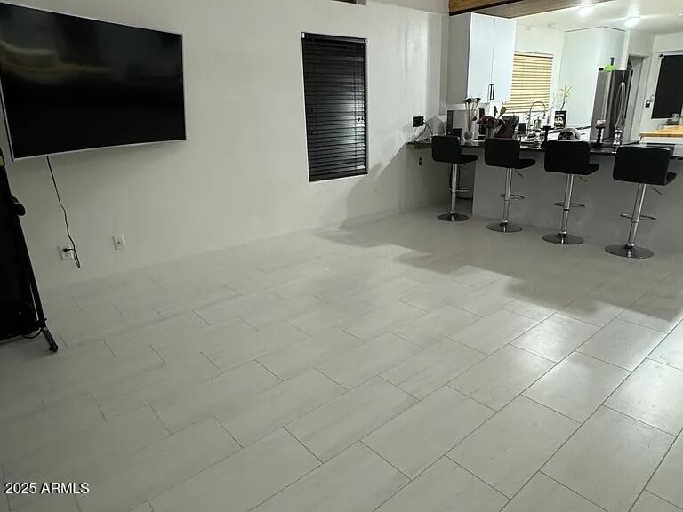 41848 West Hillman Drive Maricopa, AZ 85138 - Photo 6 of 11 a room with gym equipment and a flat screen tv