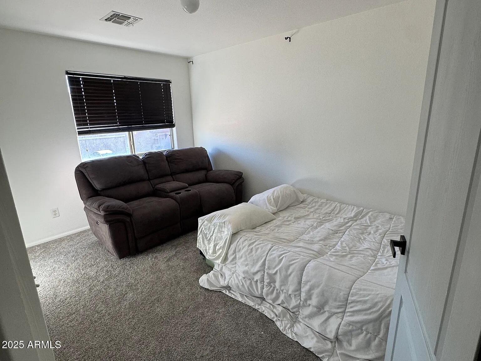 41848 West Hillman Drive Maricopa, AZ 85138 - Photo 10 of 11 a living room with furniture and a flat screen tv