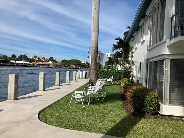 a view of a house with a yard deck and furniture