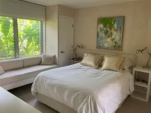 a bedroom with a large bed and a large window