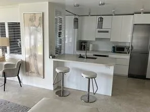 a living room with furniture and floor to ceiling window