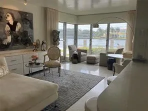 a living room with furniture and a floor to ceiling window