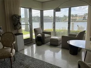a view of a living room and dining area with furniture