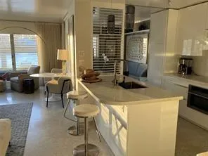a view of kitchen with granite countertop window