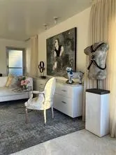 a living room with furniture and a dresser