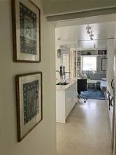 a kitchen with counter top space and living room