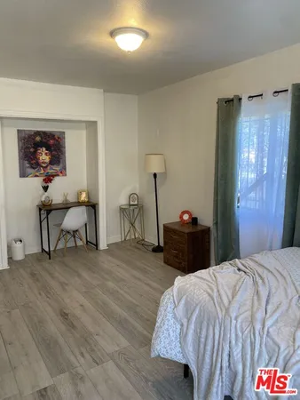 a bedroom with a bed and lamp