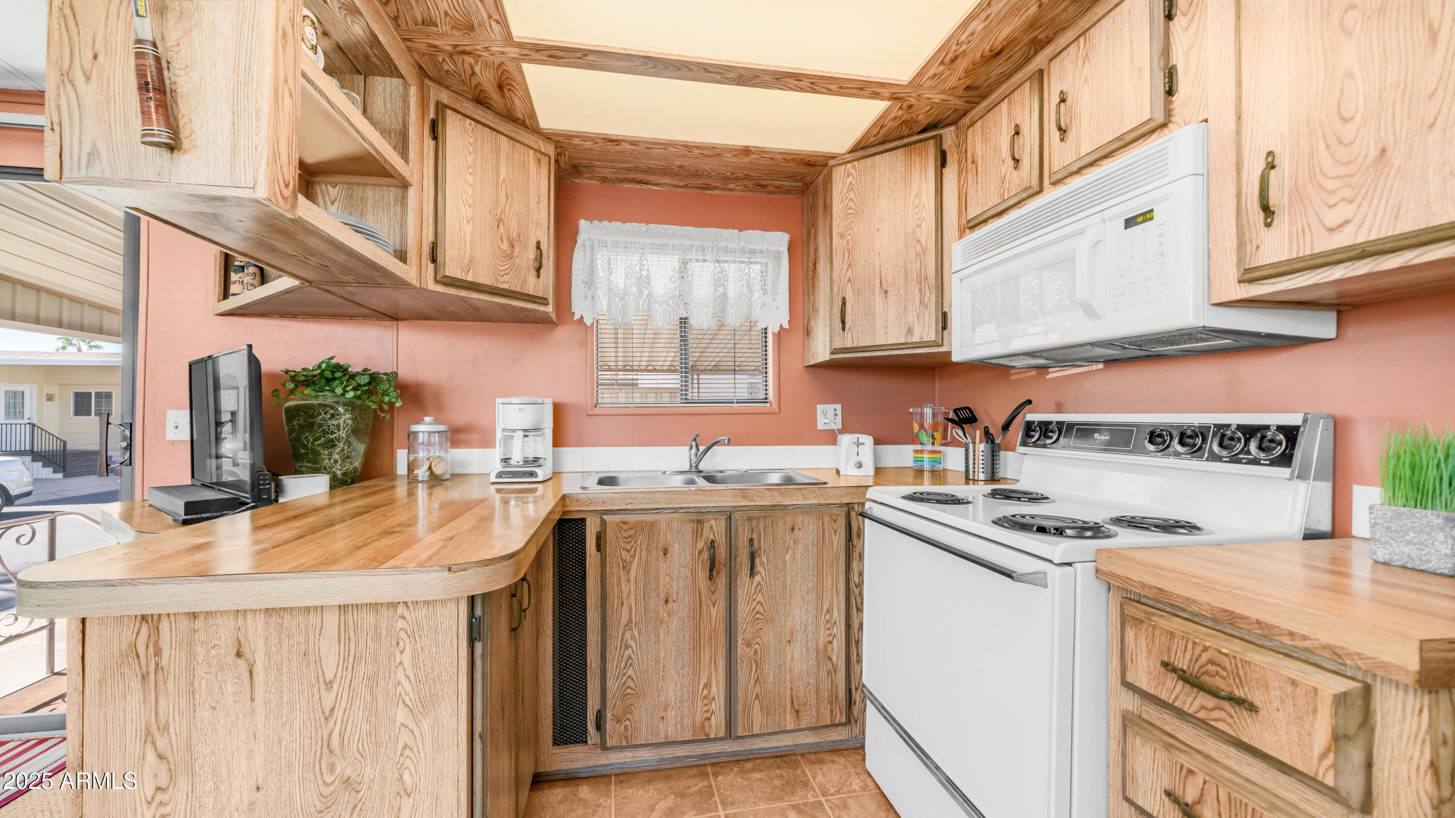 502 Jaspar Drive Apache Junction, AZ 85119 - Photo 11 of 54 a kitchen with stainless steel appliances granite countertop a sink stove and cabinets