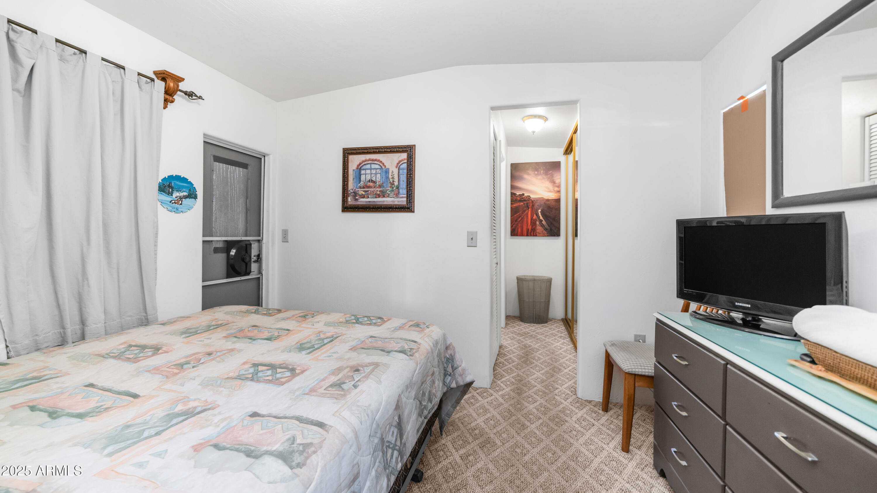 502 Jaspar Drive Apache Junction, AZ 85119 - Photo 15 of 54 a bedroom with a bed and a flat screen tv