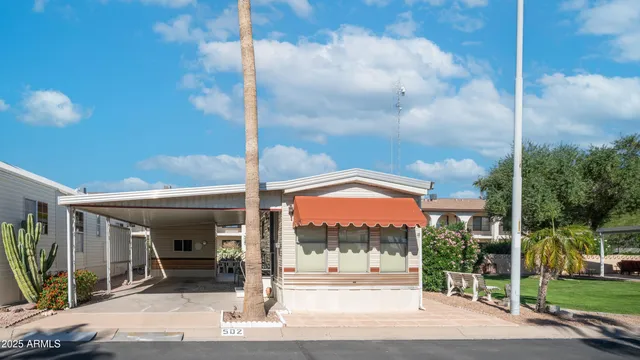 a view of a tall brick building next to a yard