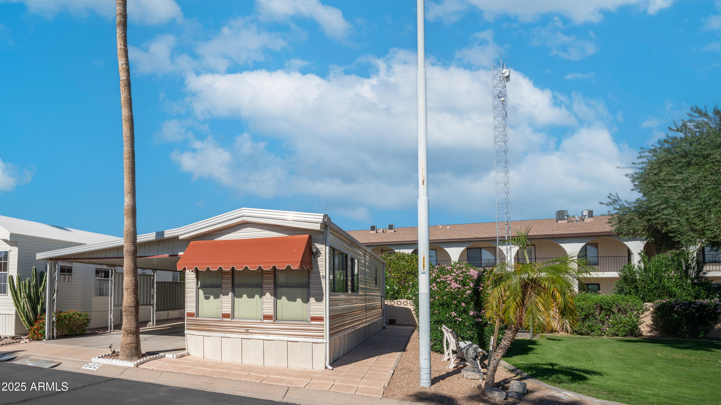502 Jaspar Drive Apache Junction, AZ 85119 - Photo 5 of 54 a view of a tall brick building next to a yard