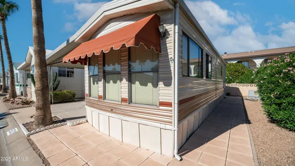 a backyard of a house with barbeque oven table and chairs