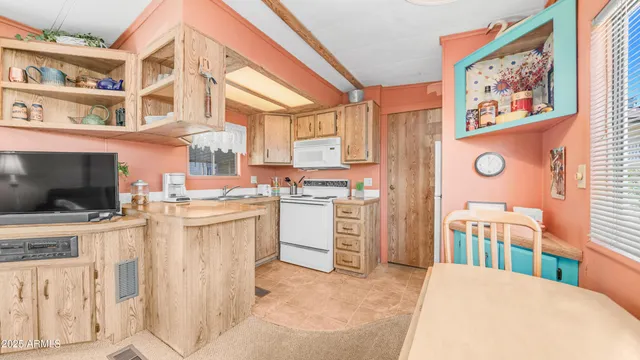 a kitchen that has a lot of cabinets in it and appliances