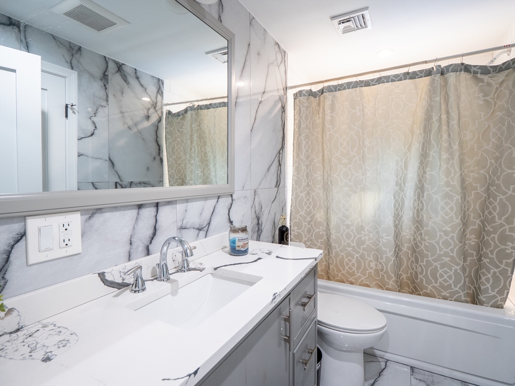 159 Mishawum Road Woburn, MA 01801 - Photo 8 of 41 a bathroom with a sink toilet and shower