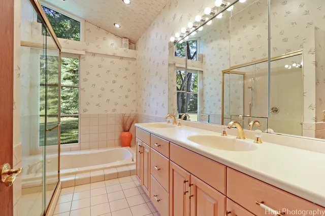 a bedroom with a bed and large window