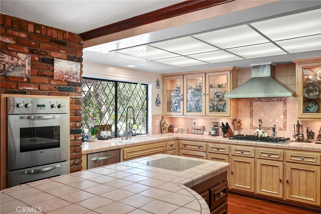 19317 Vista Grande Way Porter Ranch, CA 91326 - Photo 12 of 53 a kitchen with a sink stove and cabinets