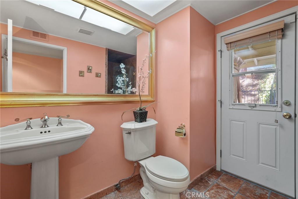 19317 Vista Grande Way Porter Ranch, CA 91326 - Photo 17 of 53 a bathroom with a sink a toilet and mirror