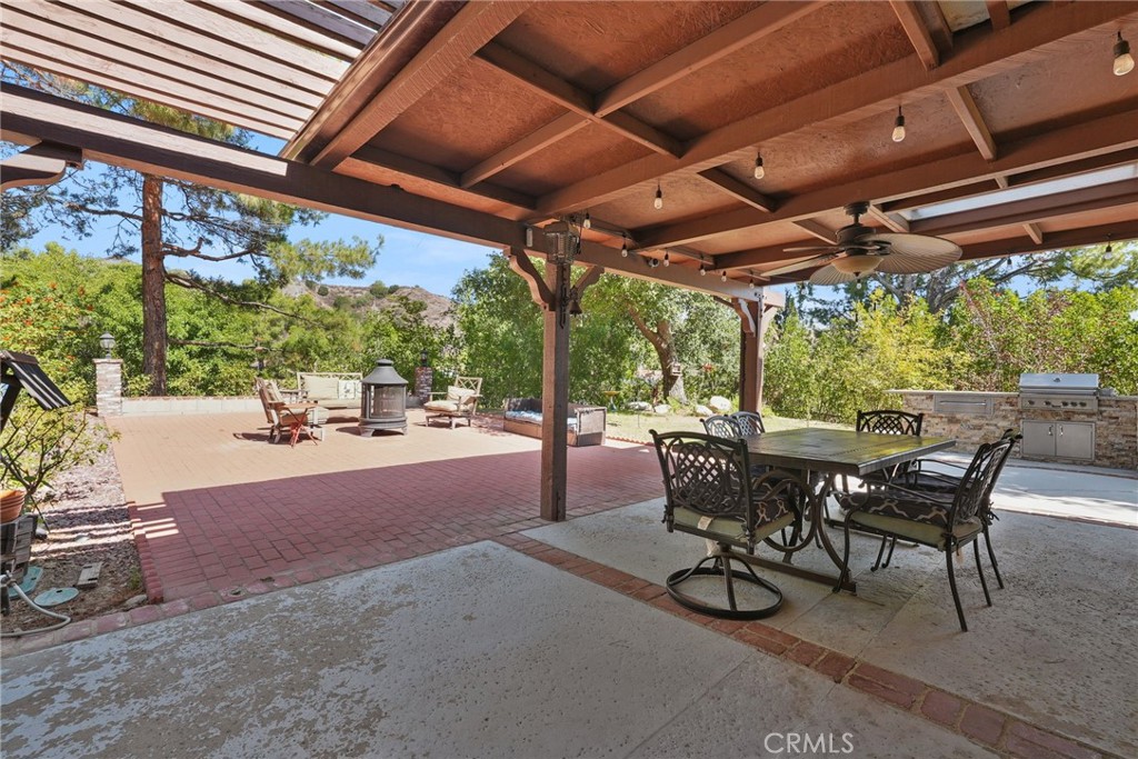 19317 Vista Grande Way Porter Ranch, CA 91326 - Photo 35 of 53 a view of a patio with table and chairs and potted plants
